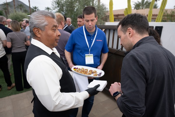 Server with food at the welcome reception