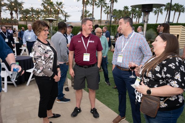 Group of attendees chatting at the welcome reception